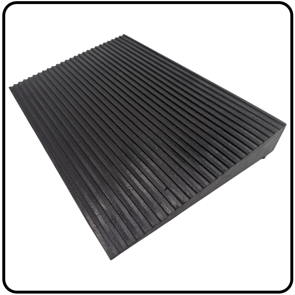 Black rubber mat with ribbed texture on a white background